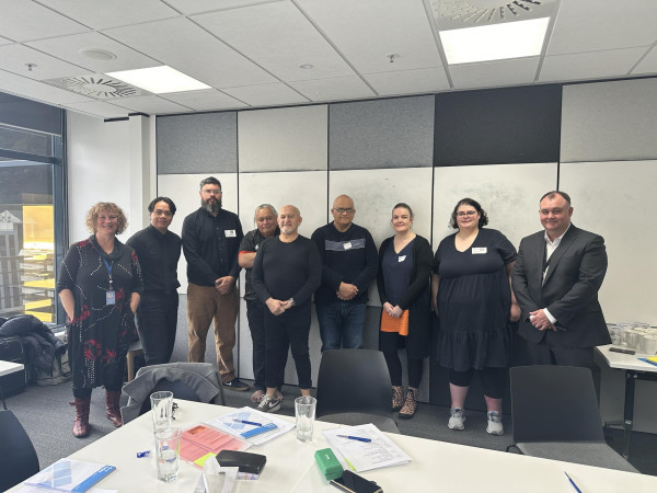 9 people, Alexandra Carr, Whiti Ronaki, Milton Reedy, Jon Tai Rakena, Nikki Dawson, Ryan Cassidy, Sam Te Maari, Jaime Randhawa and Karl McDiarmid standing together at the first meeting of the Deaf Advisory Group for the Survivor Experiences Service.